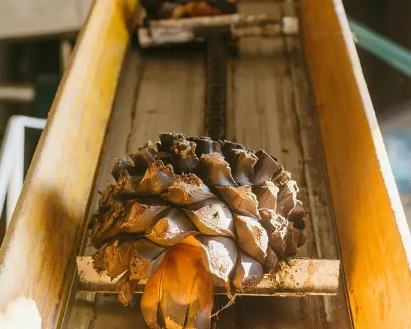 A large white cylinder with black text displaying MOS CAP. 312 0 indoors, made of steel and metal