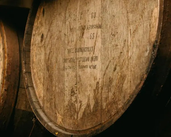 A pine cone resting on a wooden slat surface